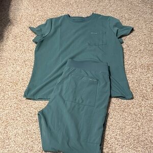 Women’s Hypothesis scrub set. 
Top has small bleach stains.